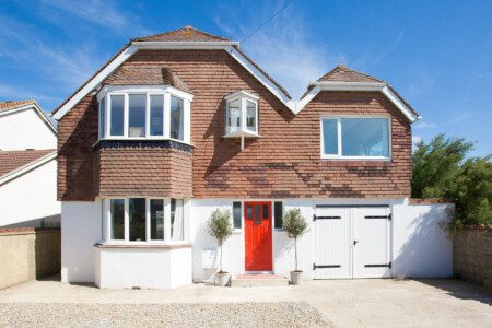 Quaint beachside retreat in West Wittering, featuring a charming red door and cosy architecture